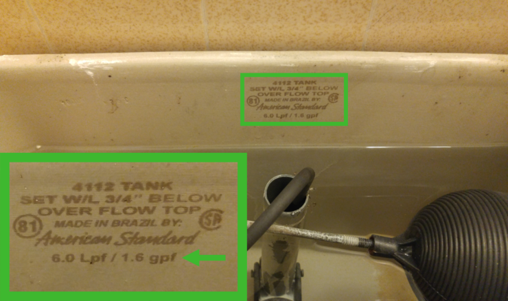 Picture of the inside of a toilet tank showing where the amount of water it uses is stamped on the back wall of the tank.