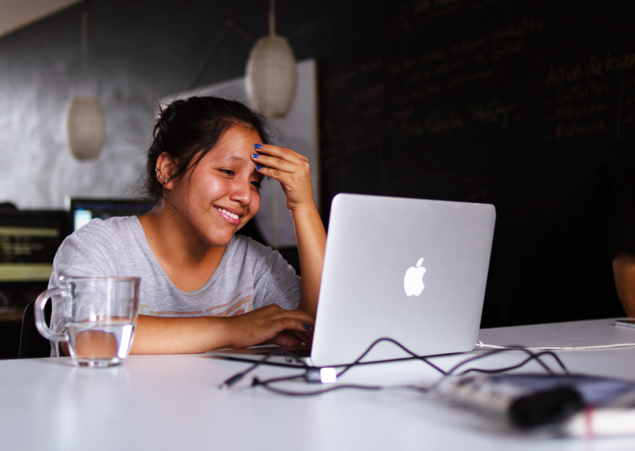 Girl smiling while working at the computer.
