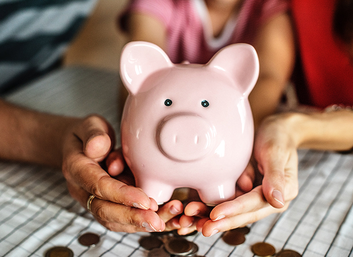 Family holding a piggy bank