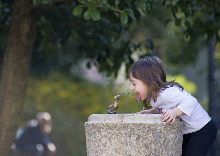 Young girl at a drinking fountain