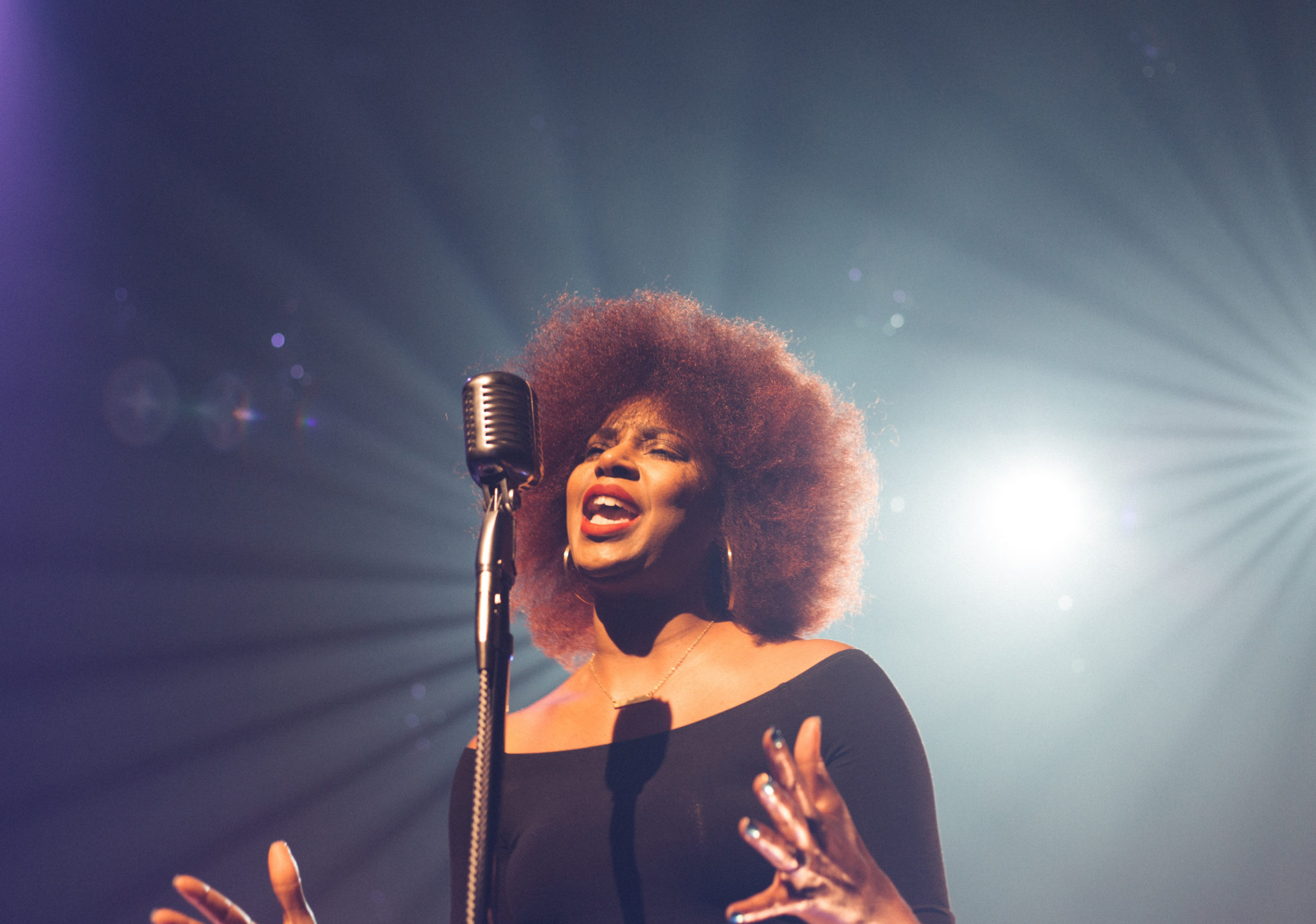 woman singing into a microphone