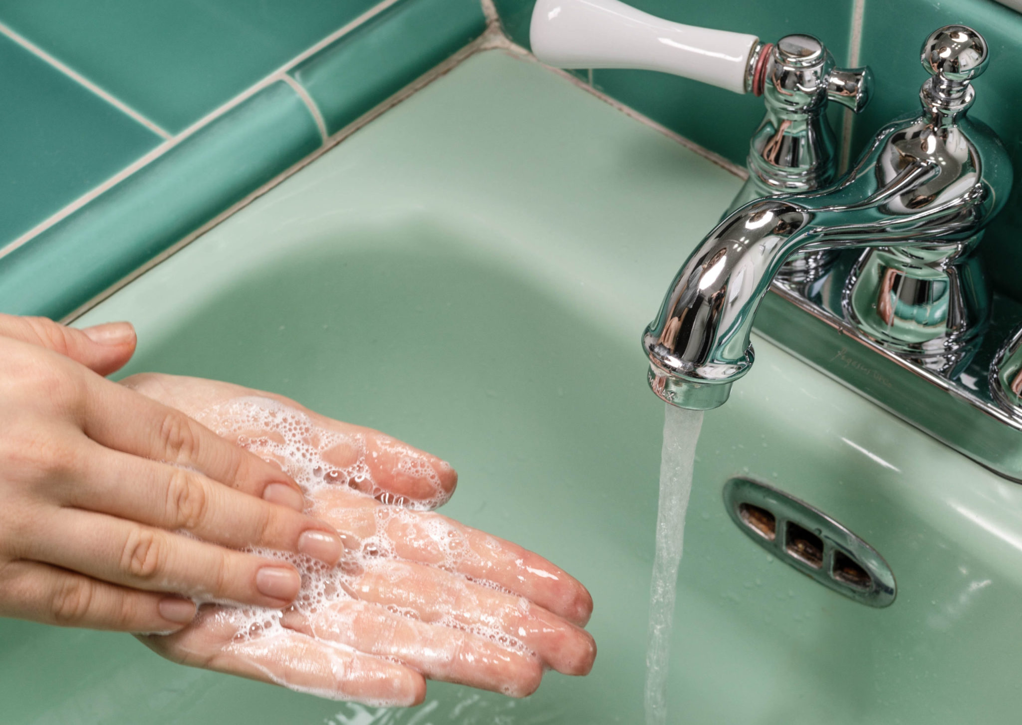 Washing hands in a bathroom sink